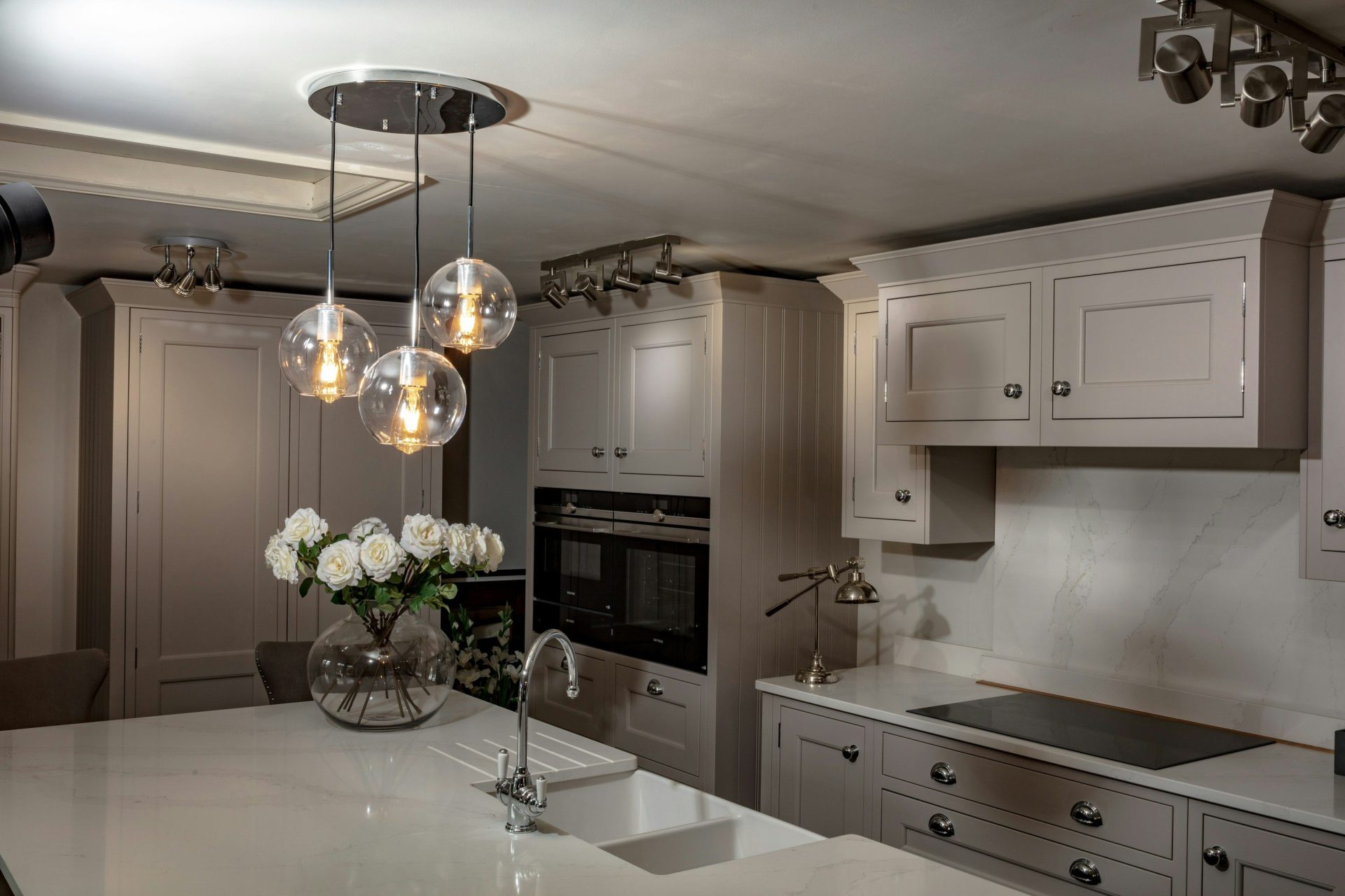 A large kitchen with a center island and a chandelier