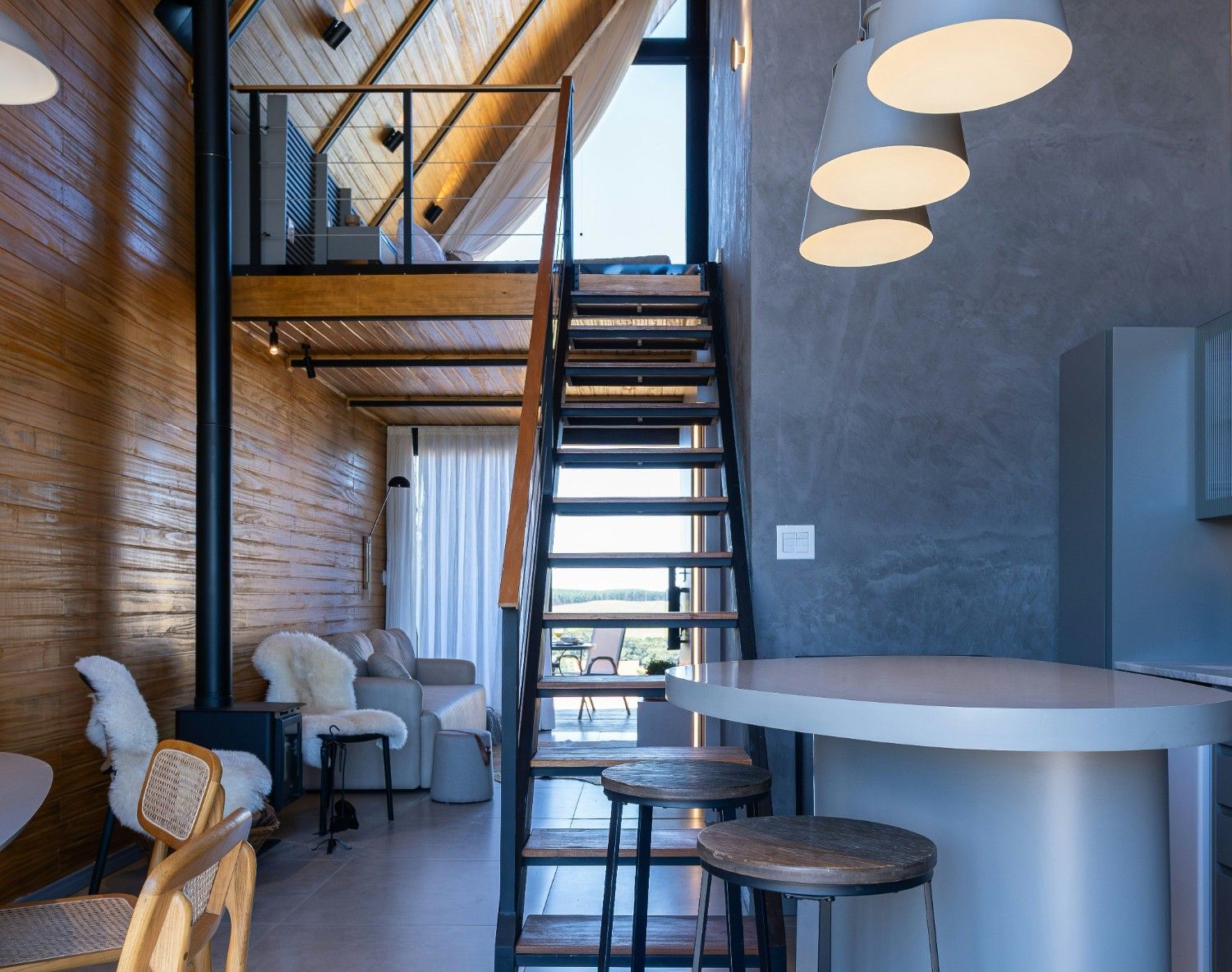 Modern interior with wooden walls and industrial staircase.